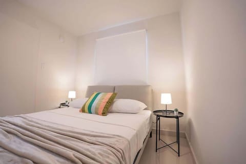 A queen bed and soft lighting create a restful place to recharge.