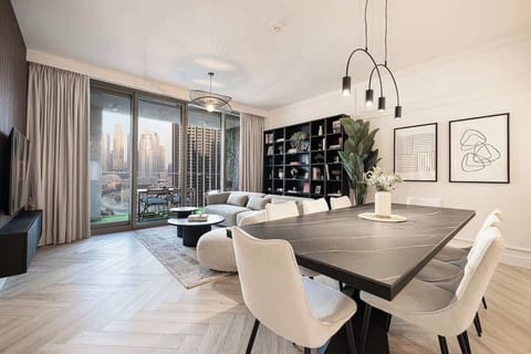Bright and cozy space with a full view of the Burj Khalifa. Big sofa, sleek dining table, and a private balcony to enjoy the city skyline. Great spot to unwind or share a meal with friends 🌇