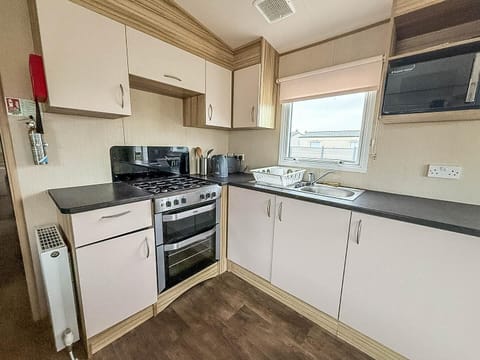 Bright, compact kitchen with modern appliances and natural light