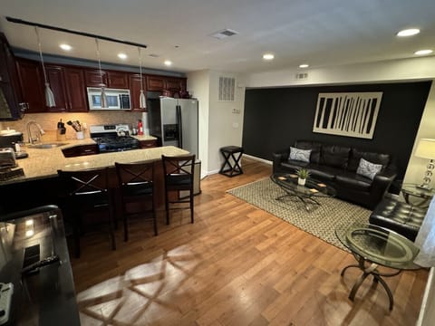 Living room /kitchen area: fridge, microwave, TV, blender, regular coffee maker, plates, silverware, cups, bowls, pen, etc.