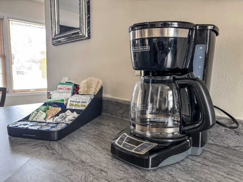 Cozy Coffee Corner – Start your day with a freshly brewed cup from the drip coffee maker, complete with regular and decaf coffee, tea, cream, and sugar. Everything you need for a warm and welcoming morning.
