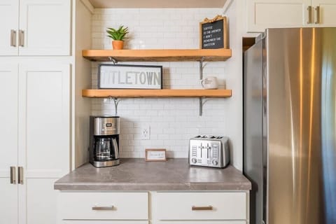A well-stocked coffee station featuring a high-quality coffee maker, a selection of coffee, sugar, creamer, and mugs. Conveniently located for a quick morning boost, this cozy setup ensures guests can enjoy their perfect cup of coffee.