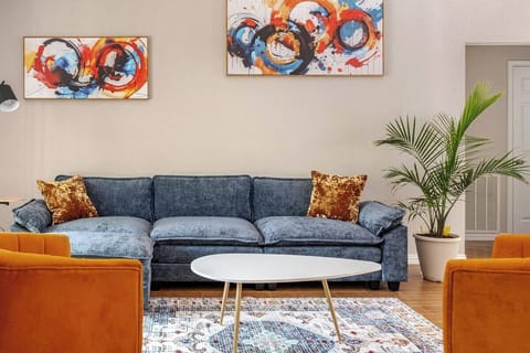 Comfortable seating, smart TV, open layout and playful pops of color to relax.