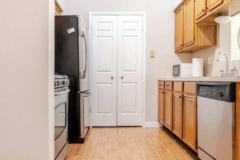 The warm wood cabinetry adds charm, while the modern appliances make it easy.