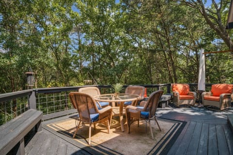 Surrounded by trees and nature, this stunning, expansive deck invites you to relax, dine outdoors, and soak in the peaceful forest views.