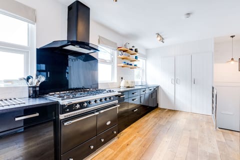 Zareba, St Ives. Ground floor: Kitchen one with a gas range cooker, dishwasher and American style fridge/freezer