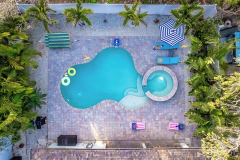 Private poolside paradise—sparkling pool, spa, and shaded loungers await.