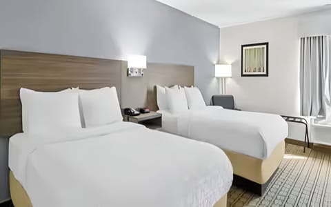 Unwind in crisp linens with roomy double-queen comfort.