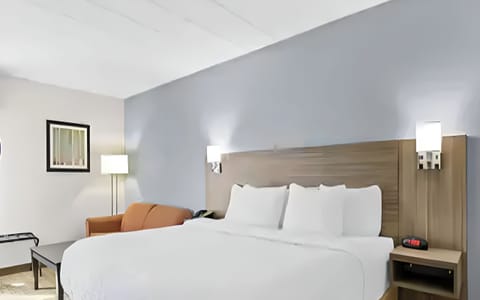 Stretch out on a modern king bed with warm lighting.