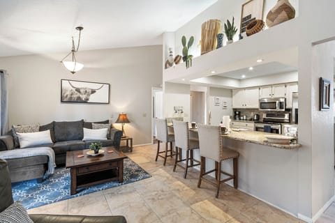 Island with seating for three (3), open concept to living room.