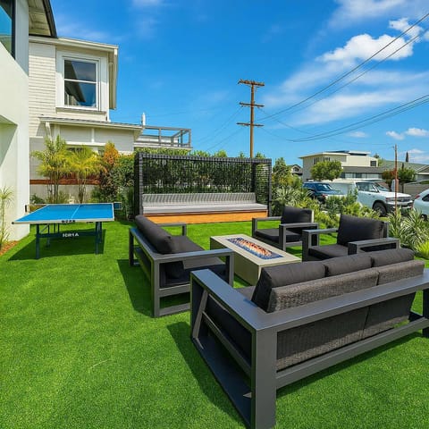 Escape to our stylish retreat! Enjoy the sun-drenched patio with plush seating, a fire pit for cozy evenings, & a ping pong table for fun. Modern design meets comfort in this unique space. Perfect for relaxing getaways.