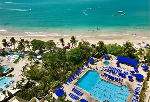 Balcony View – Enjoy stunning ocean views, palm trees, and poolside vibes right from your balcony in beautiful Isla Verde, Puerto Rico.