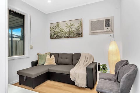 Settle into the cosy living room after a day of shopping or sightseeing—perfect for movie nights, quiet reading, or simply cooling off with split system air conditioning.
