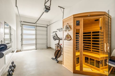Spacious gym area featuring an infrared sauna and fitness equipment