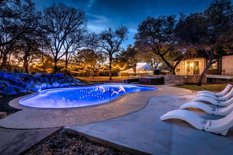 Twilight escape with a glowing pool and cozy, light-filled ambiance.