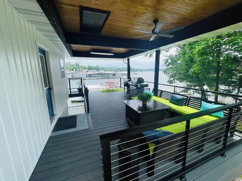 Relax on the Upper deck. Use the pellet smoker for some phenomenal BBQ or get breakfast going on the outdoor griddle. TV viewing optional, just push a button and the TV will lower down.  @WetFeetRetreats!