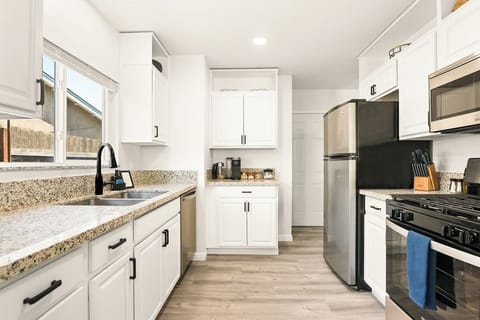 Fully stocked kitchen, with ample dishware, glassware, serving ware, pots & pans