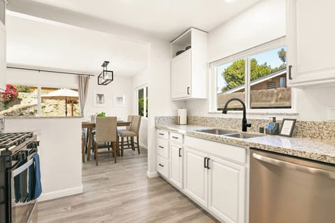 Kitchen includes toaster, mixing bowls, rice cooker, food processor.