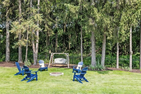 Fire pit in back of yard with swing