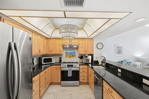 Well-stocked kitchen with modern appliances and plenty of counter space for preparing meals with ease.