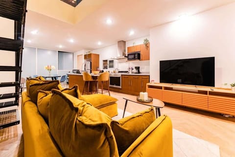 The sitting area features a plush sofa and Smart TV