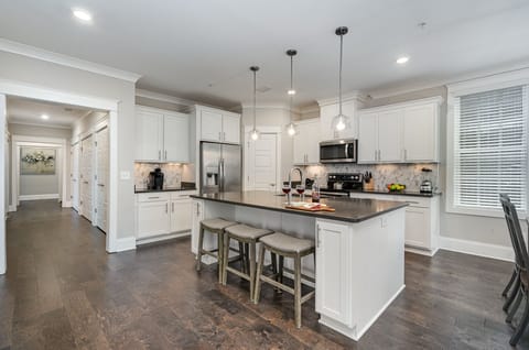 Unit 2 (2nd Floor): Fully equipped kitchen stocked with all culinary essentials, stainless steel appliances and an island offering bar seating for 3 guests.