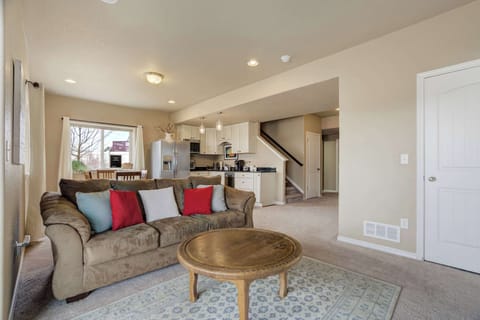 Open-concept living area with a cozy sofa, coffee table, and direct connection to the kitchen and dining space, creating a welcoming atmosphere for relaxation and socializing.






