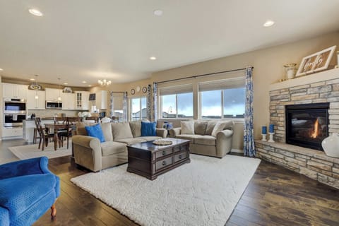 Open-concept living area seamlessly connecting the cozy living room, dining space, and modern kitchen. Enjoy mountain views from the large windows while relaxing by the stone fireplace. Ideal for socializing and making memories!