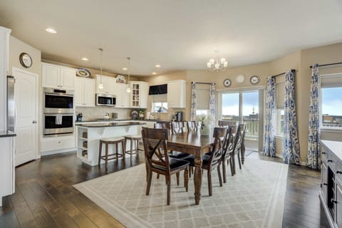 Elegant dining area with seating for the whole family, surrounded by large windows that showcase beautiful views. Perfect for enjoying meals together or hosting gatherings, with seamless access to the living room and kitchen.