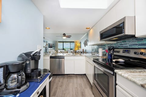 This kitchen features additional appliances, including a Keurig and coffee pot, perfect for the morning rise and shine