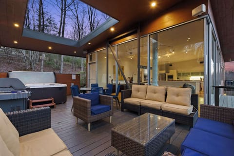 Relax in this stunning outdoor lounge with a cozy seating area, hot tub, and breathtaking views! 