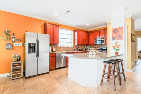 a warm and functional kitchen with a GE refrigerator and a playful twist.