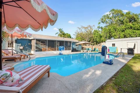 Outdoor Oasis: Dive into fun with a sparkling pool, vibrant lounge chairs, and sunny vibes!