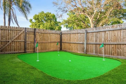 Backyard Oasis: Enjoy putting green fun and vibrant seating in your private outdoor paradise!
