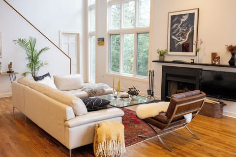 Modern finishes and floor to ceiling windows framing surrounding forest.