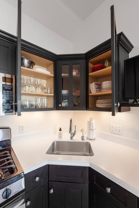 Kitchen stocked w/ serveware for four, ready for easy meals.