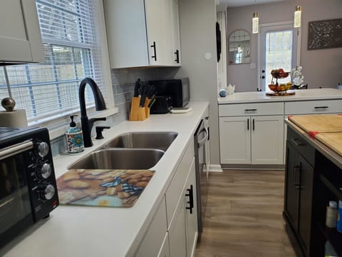 Full kitchen with island. All new appliances, basic spices and condiments