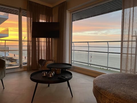 Warm sunset light pouring through the living room — peaceful and golden.