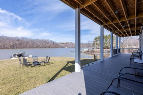 Lakefront patio with firepit and lounge seating 