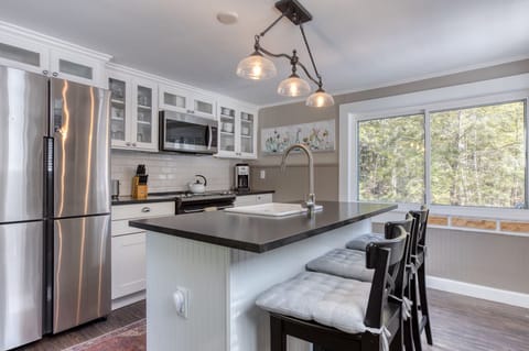 Fully stocked kitchen with stainless steel appliances.