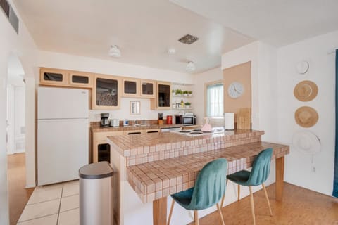 The kitchen is compact and functional with a bright and airy design.
