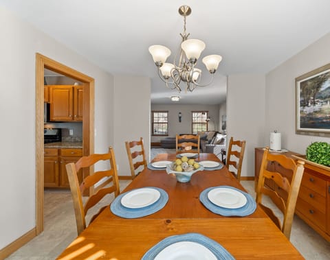 Sun-filled dining area with big windows and a cozy atmosphere.
