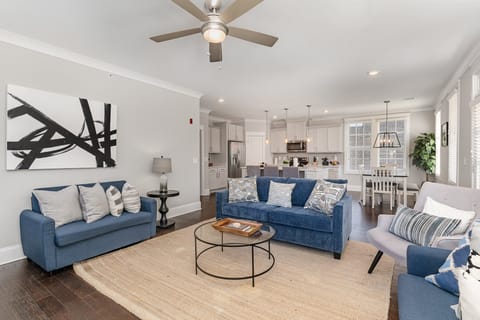 Unit 2: An open and inviting living space featuring a Smart TV and cozy furnishings, including 1 Queen sleeper sofa and 2 Twin sleeper sofas. Access to private balcony.