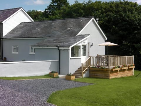 The exterior of Llaethdy Rachel with raised decking on the side of the house
