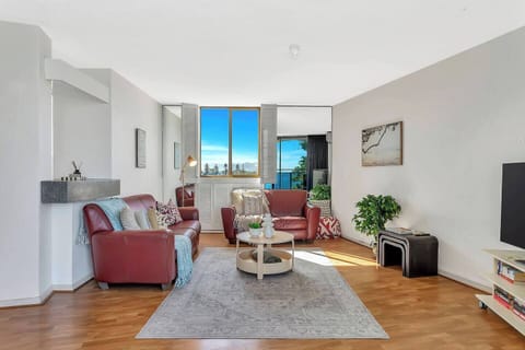 Step into the open-plan living area, where soft leather seating and greenery touches invite you to unwind with your favourite movies.