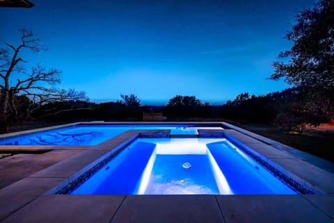 A breathtaking pool glowing under the night sky.