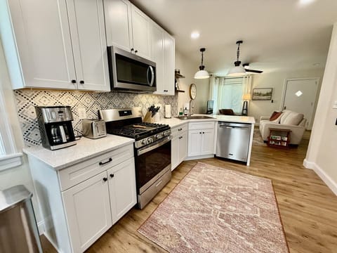 Stylish kitchen with quartz countertops, modern appliances, and cozy bar seating.