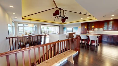 Spacious and elegant open concept great room with grass cloth ceilings