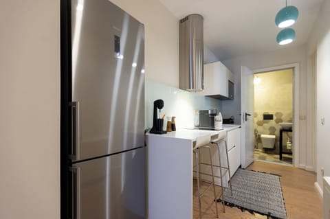 The fully equipped kitchen has all modern appliances, a GAGGENAU stove & microwave, perfect for a self-catered holiday, and a breakfast bar with two stools.