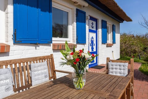 Terrace with Wooden Table and Bouquet